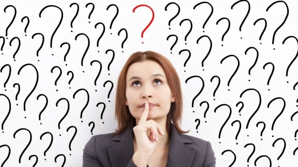 Woman wondering what she should do, surrounded by question marks